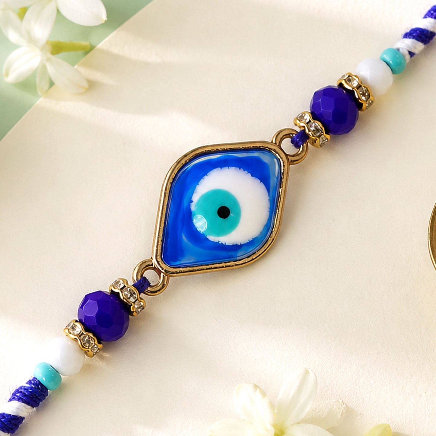 Stylish Evil Eye Rakhi with Beaded String and Protective Center Charm