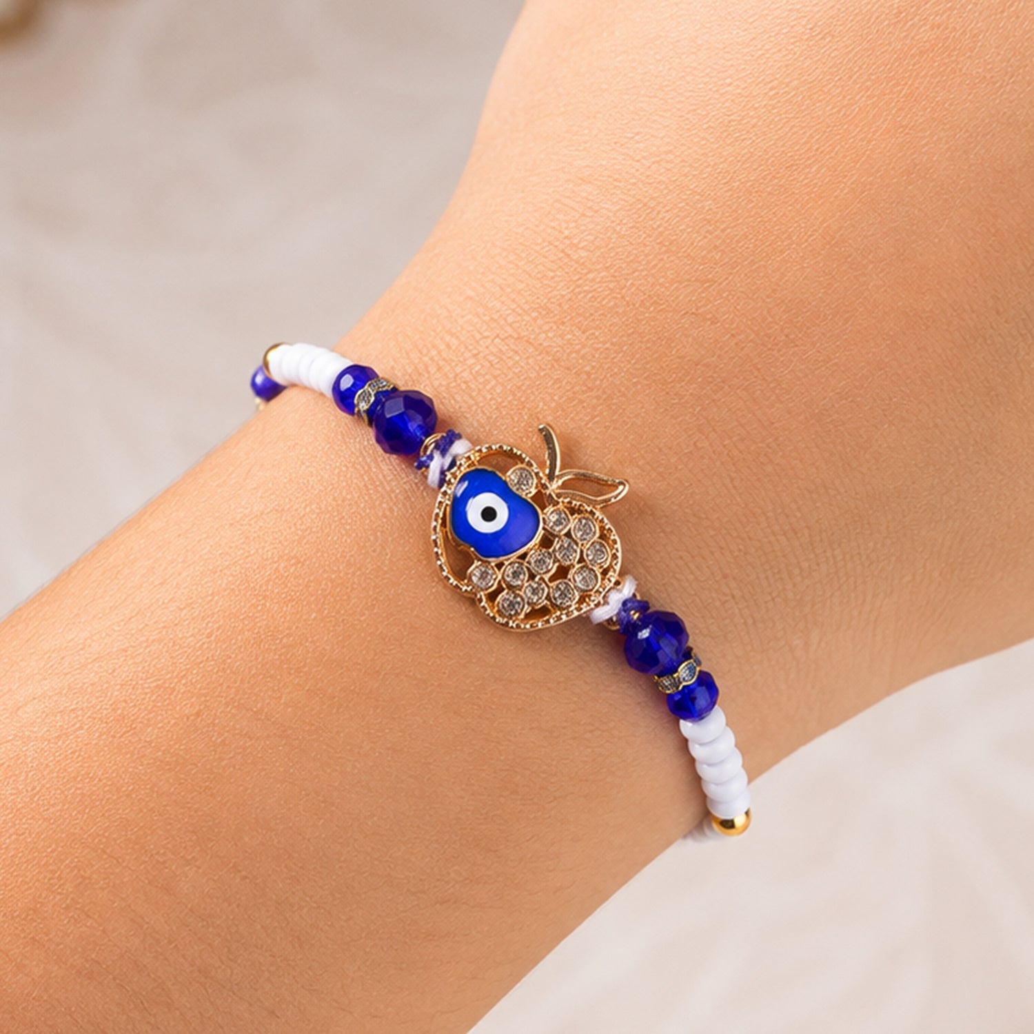 Crown Evil Eye Crystal Beaded Rakhi with Ornate Round Center Charm