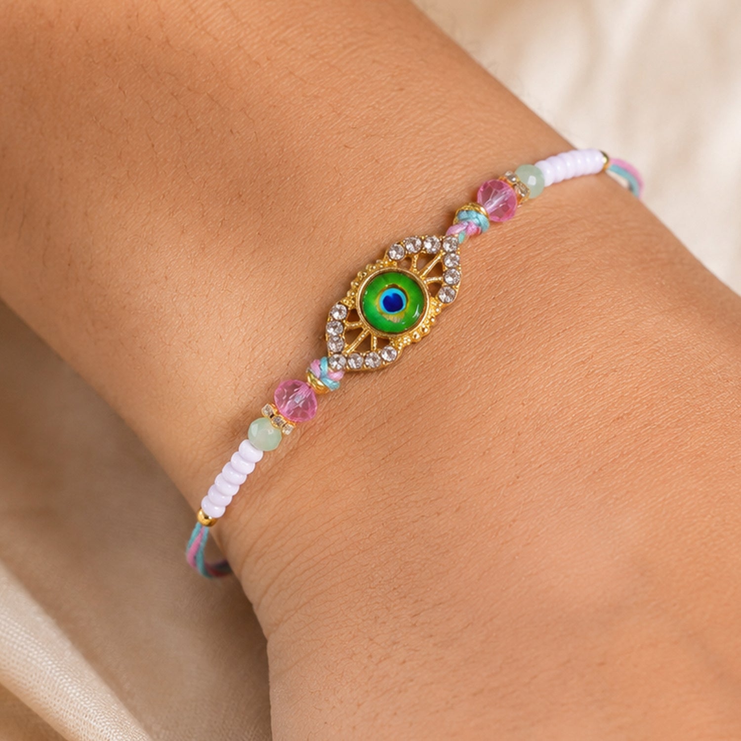 Peacock Feather Kundan Beaded Rakhi with Floral Center Charm Design