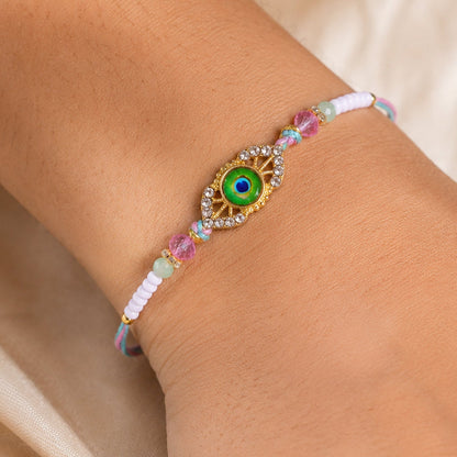 Peacock Feather Kundan Beaded Rakhi with Floral Center Charm Design