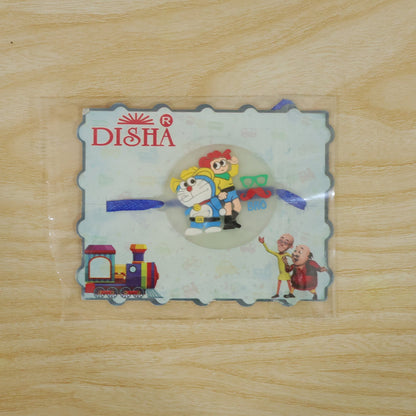 The Doraemon and Nobita Rakhi with a 'BRO' charm, packaged in a clear plastic sleeve with a DISHA branded card.