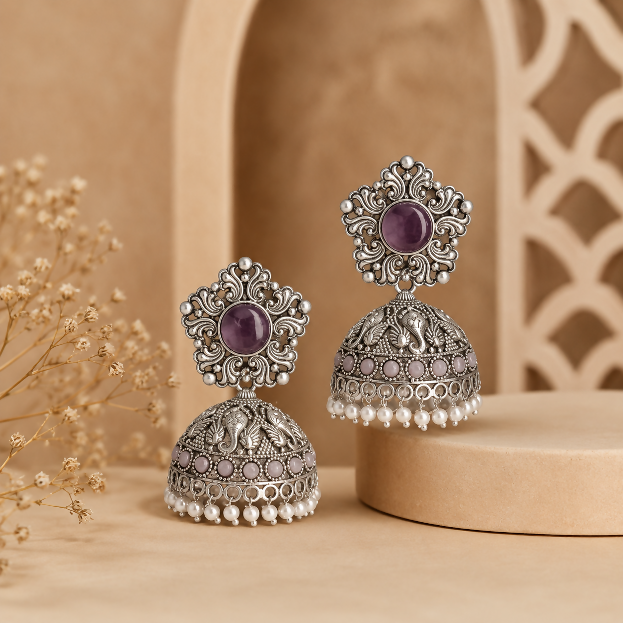 Side view of oxidized silver jhumka earrings highlighting pearl drops