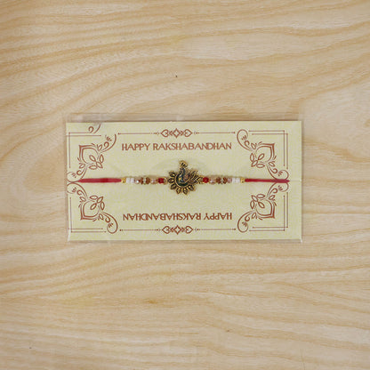 Peacock Floral Golden Rakhi with Blue Green Enamel, Pearl Beads and Red Thread