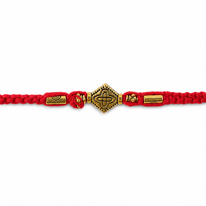 Red Thread Rakhi with an Intricately Detailed Antique Gold Charm