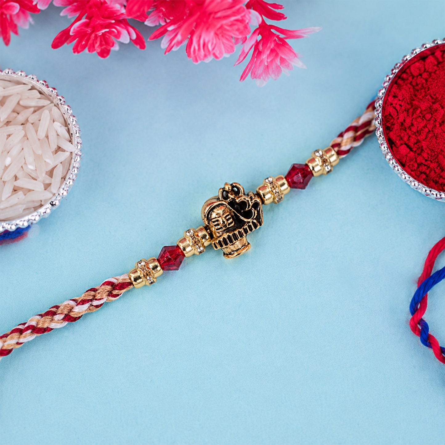 Sacred Deity Rakhi with Red-Beige Thread and Gold Pendant for Raksha Bandhan Gift