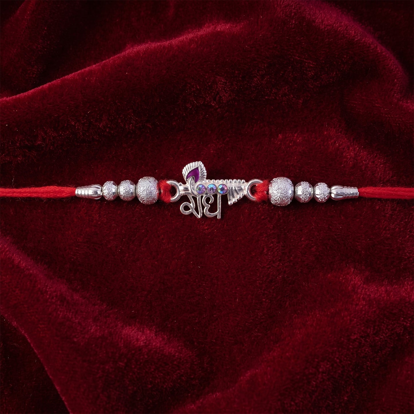 Elegant Radhe Silver Rakhi with Decorative Beads and Red Thread
