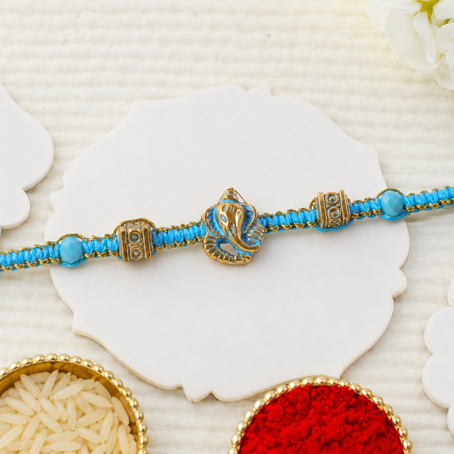 Turquoise Center Designer Rakhi with Gold Tone Detail and Elegant Bracelet Beauty