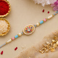Pearl Bordered Oval Kundan Pendant Rakhi with Pastel Beads