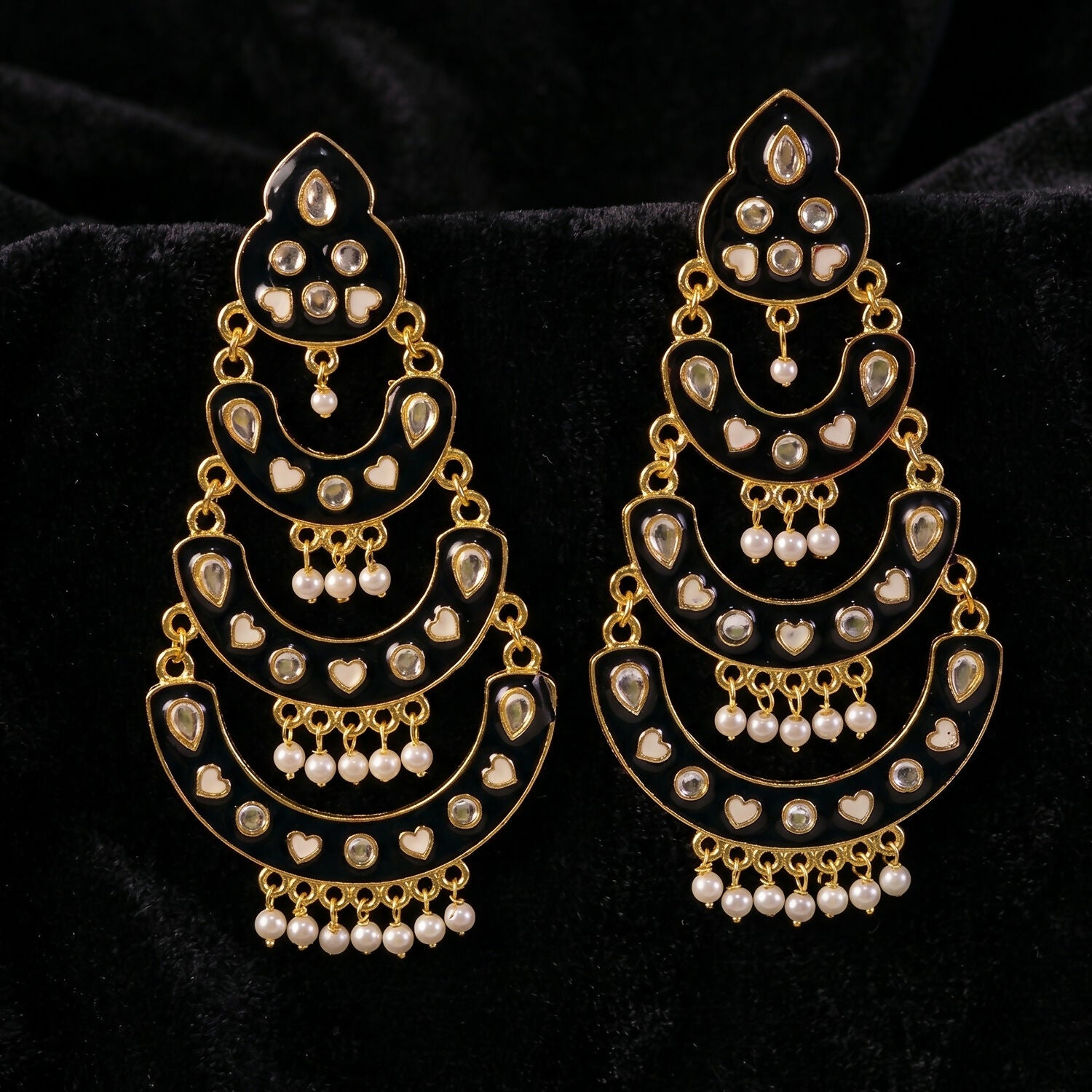 Artistic shot of maroon chandbali earrings showcasing heart accents