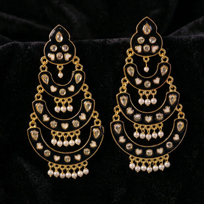 Artistic shot of maroon chandbali earrings showcasing heart accents