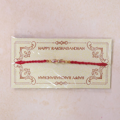 Red Thread Rakhi with Champagne Crystal Bead Pendant Accents