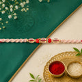 Peach Twisted Cord Rakhi with Red and Sparkling Crystal Bead Accents