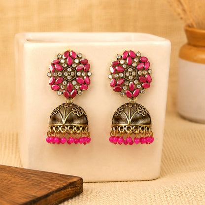 Pink stone floral top on antique gold jhumka earrings