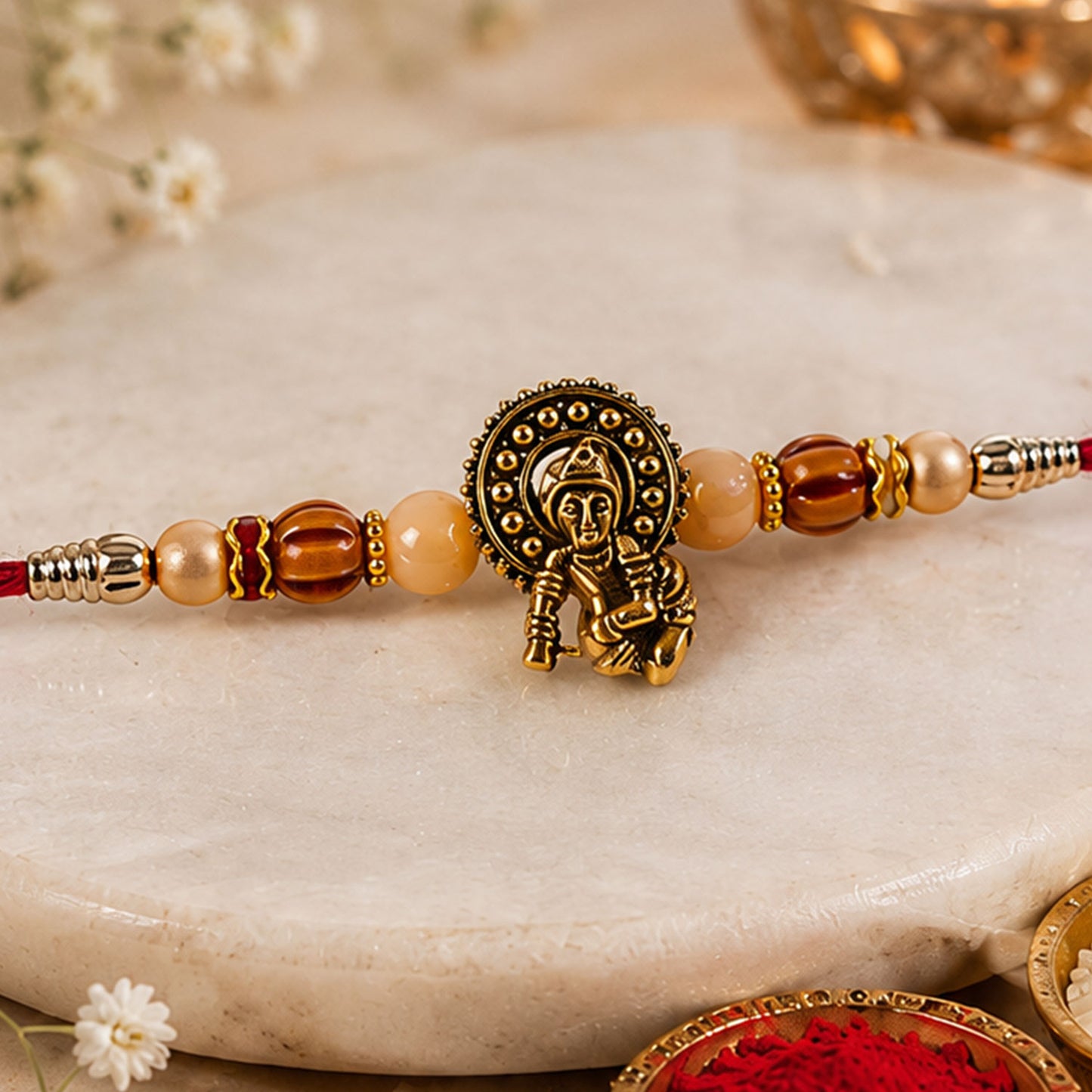 Antique Deity Idol Devotional Rakhi with Golden Medallion, Peach Beads and Red Thread
