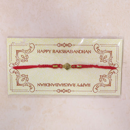 Red Thread Rakhi with an Intricately Detailed Antique Gold Charm