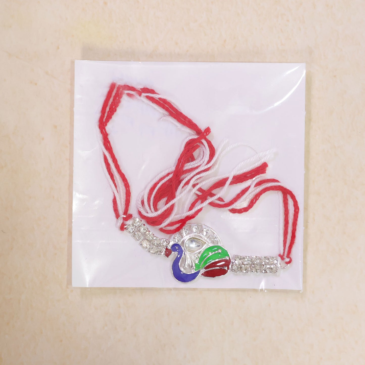 Silver-Toned Peacock Rakhi with Multicolor Enamel, Kundan-Style Stone & Double Crystal Chain