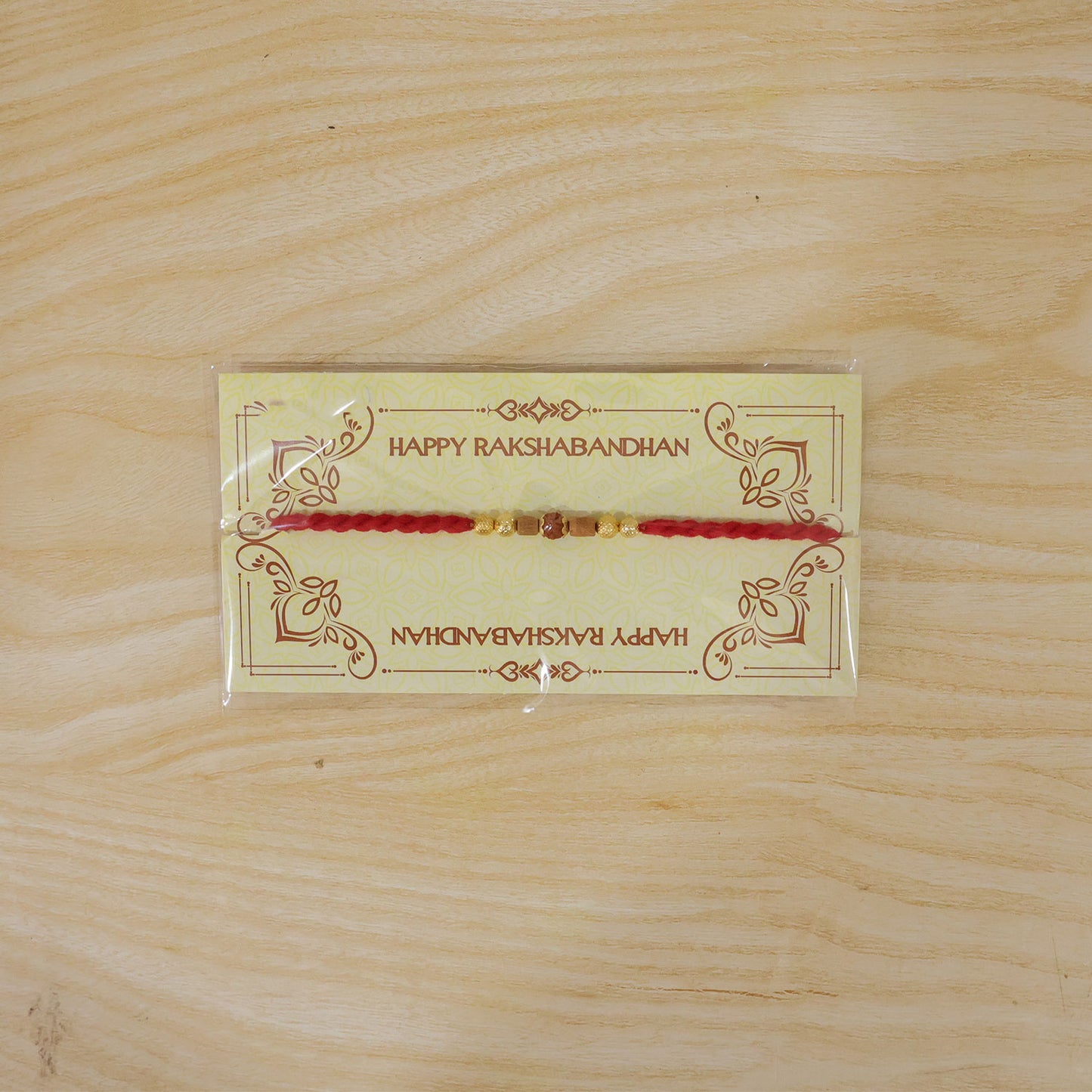 Red Cord Rakhi with Rudraksha and Natural Wooden Bead Accents