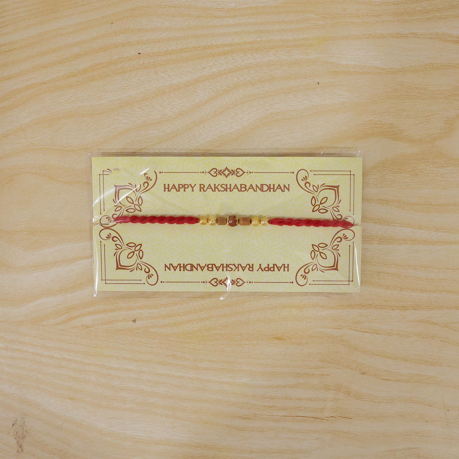 Red Cord Rakhi with Rudraksha and Natural Wooden Bead Accents