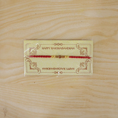 Red Cord Rakhi with Rudraksha and Natural Wooden Bead Accents