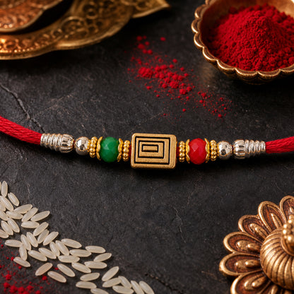 Red Thread Rakhi with Carved Golden Rectangular Charm Pendant