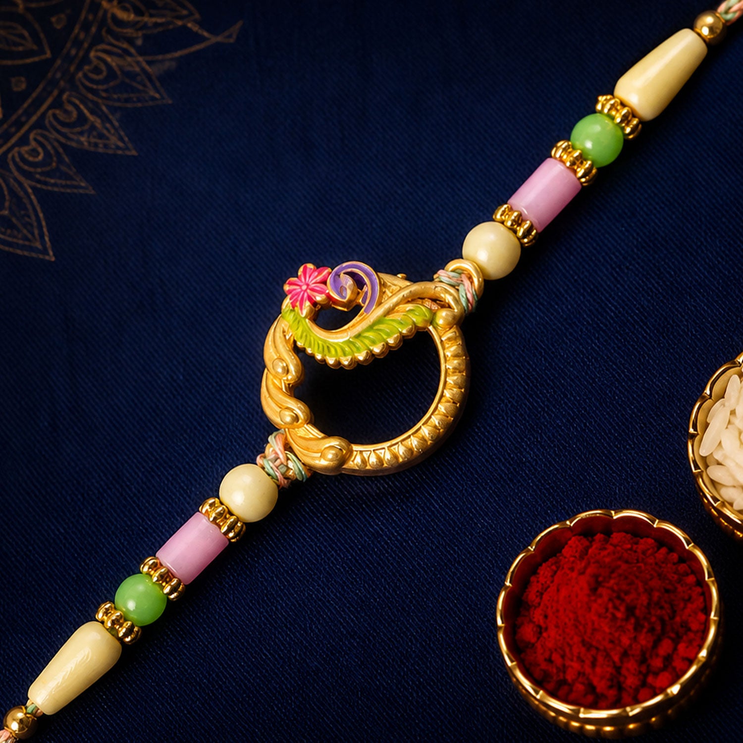 Golden Circular Rakhi with Pink Green Beads and Refined Festive Brother Gift Appeal