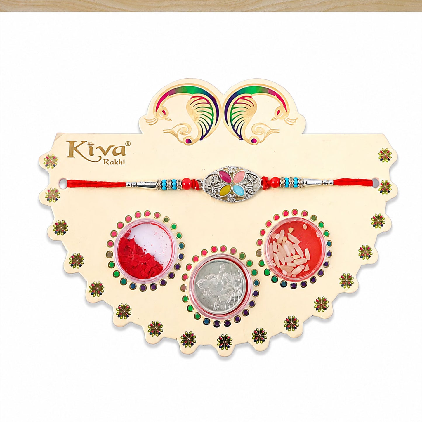 Silver Oval Floral Stone Rakhi with Color Petal Centre, Roli Chawal Coin and Card Packing
