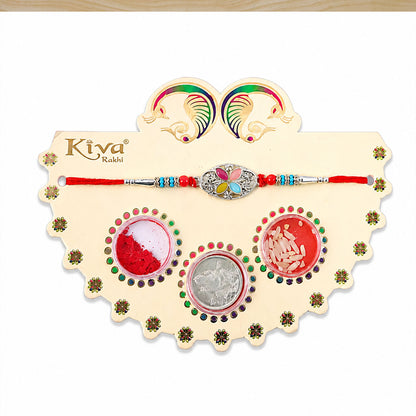 Silver Oval Floral Stone Rakhi with Color Petal Centre, Roli Chawal Coin and Card Packing