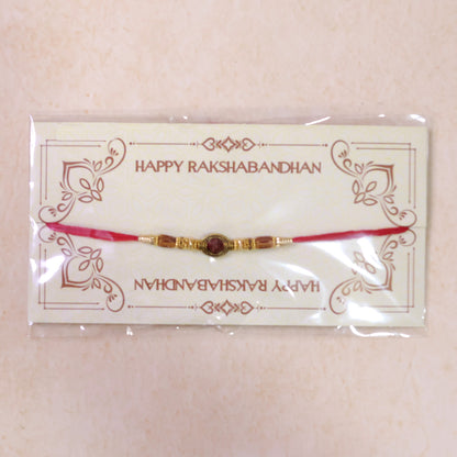 Red Thread Rakhi with Amber Beads and Antique Gold Oval Charm