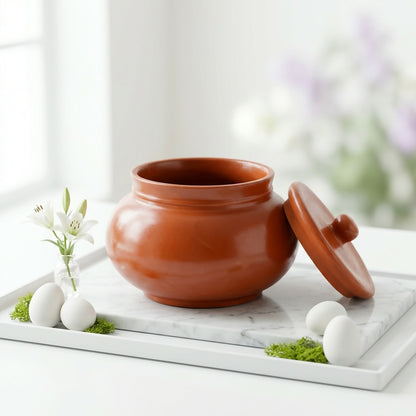 Side view of natural terracotta dahi handi pot with lid