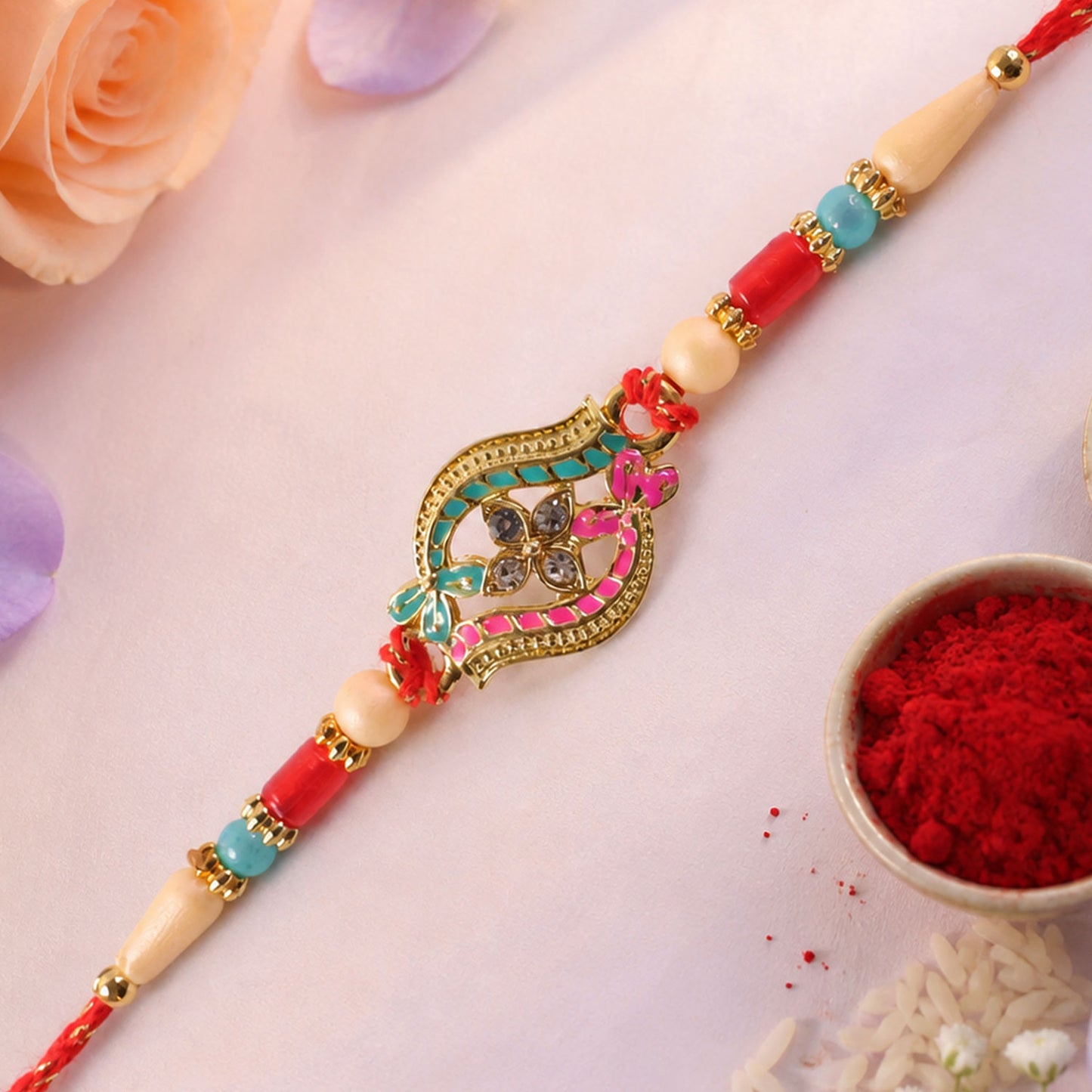 Golden Filigree Oval Floral Centerpiece Rakhi with Pink & Turquoise Enamel Detail