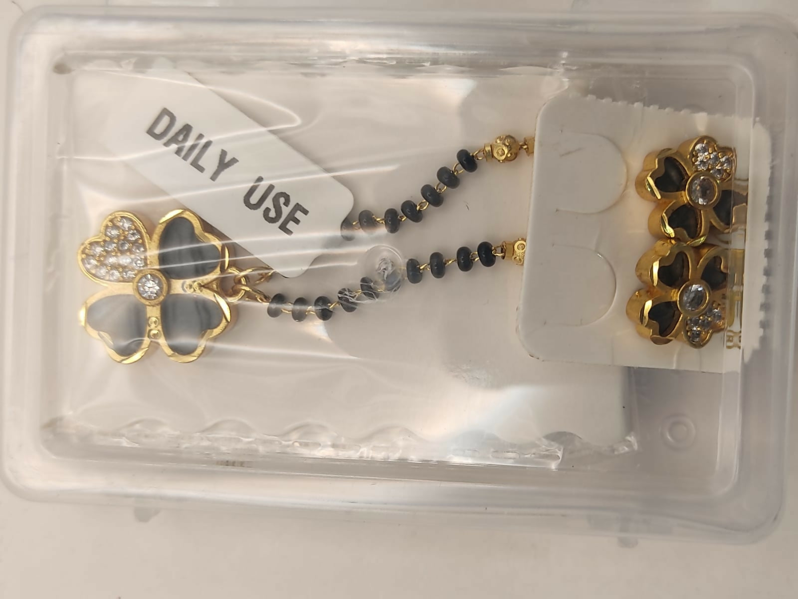 Complete floral mangalsutra and earring set with black beads and gold-toned accents