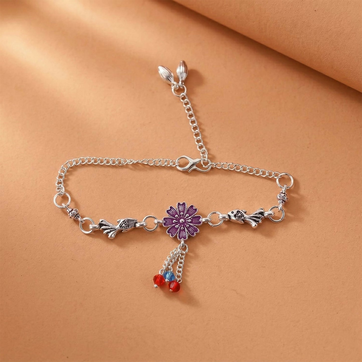 Silver flower charm bracelet with purple flower center and beads