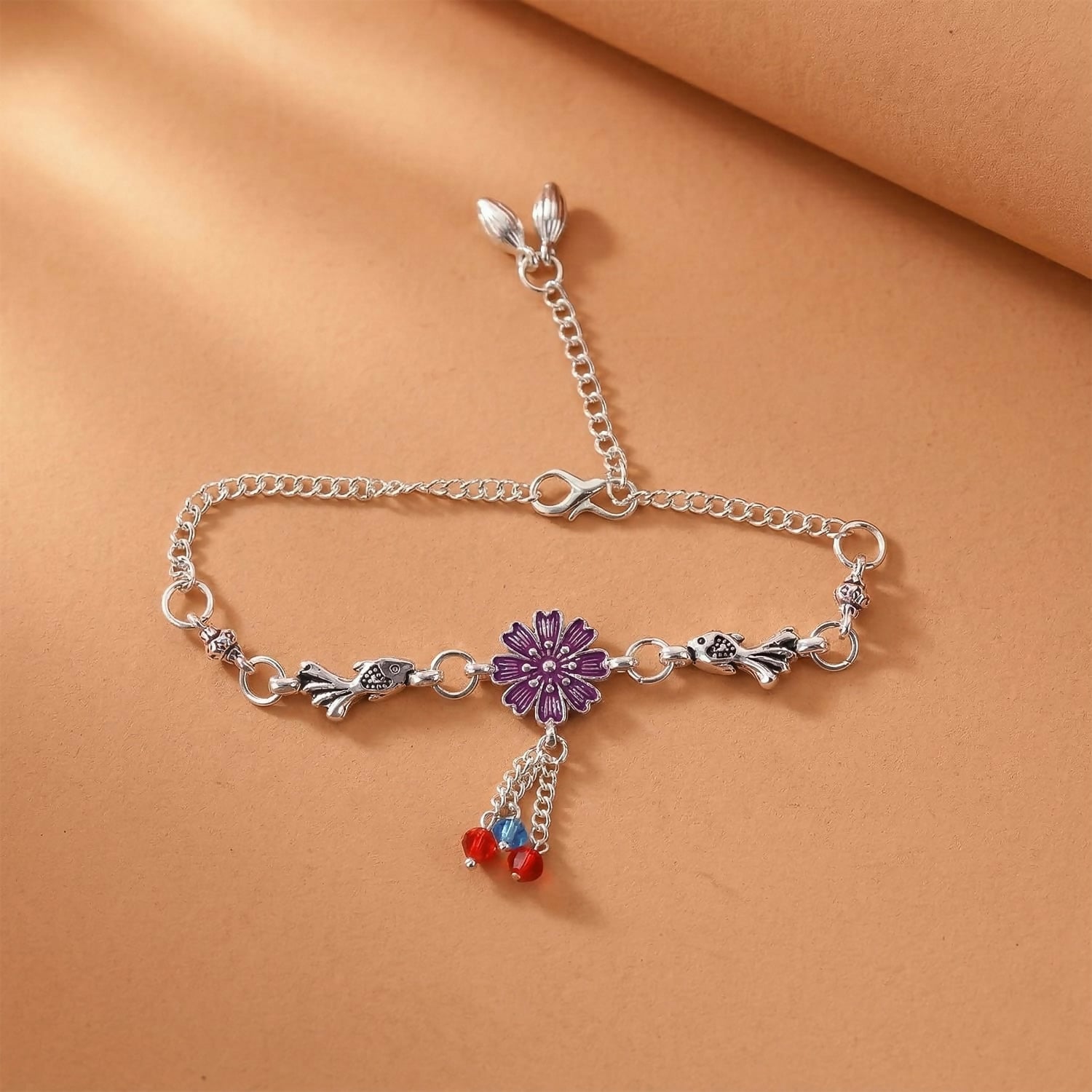 Silver flower charm bracelet with purple flower center and beads