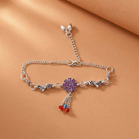 Silver flower charm bracelet with purple flower center and beads