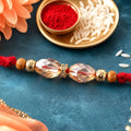 Red Thread Rakhi with Champagne Crystal Bead Pendant Accents