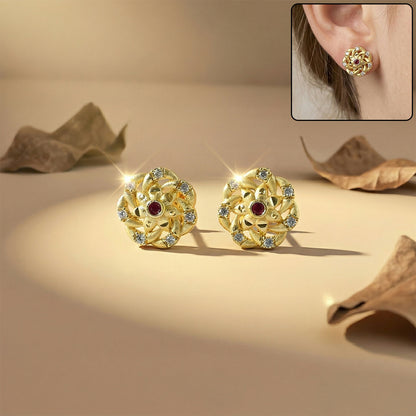 Close-up of gold floral cluster stud earrings adorned with sparkling stones