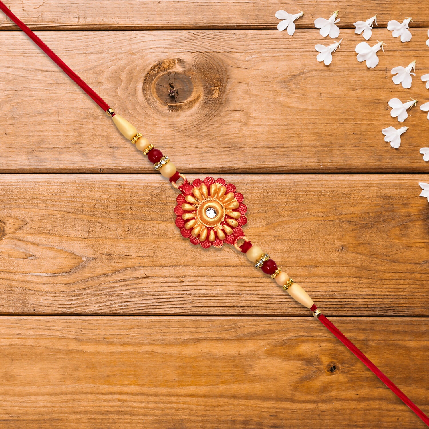 Close-up of floral bead rakhi design with central stone
