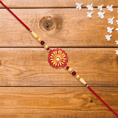 Close-up of floral bead rakhi design with central stone