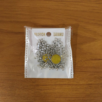 Front view of oxidized silver filigree earrings with yellow stone and dangles