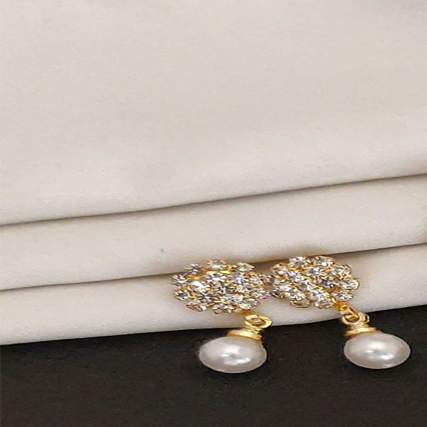 Close-up view of elegant traditional jhumka earrings in gold plating
