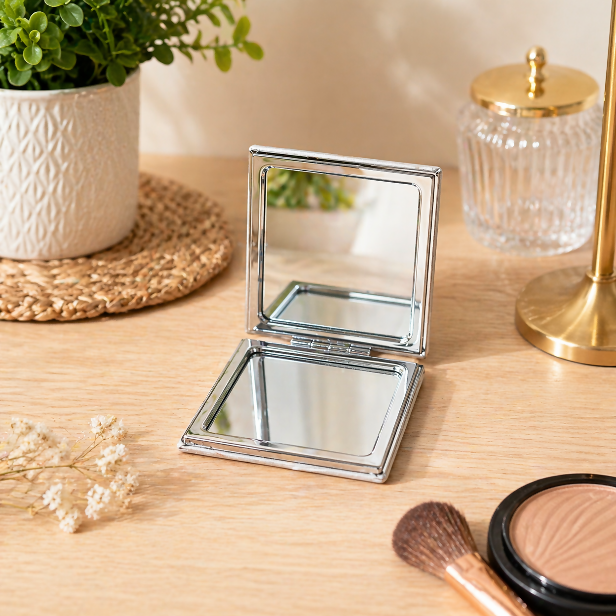 Open compact folding makeup mirror showing clear reflective surface