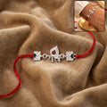 Rakhi – Elegant Silver Radhe Morpich with Green Stones for Brother
