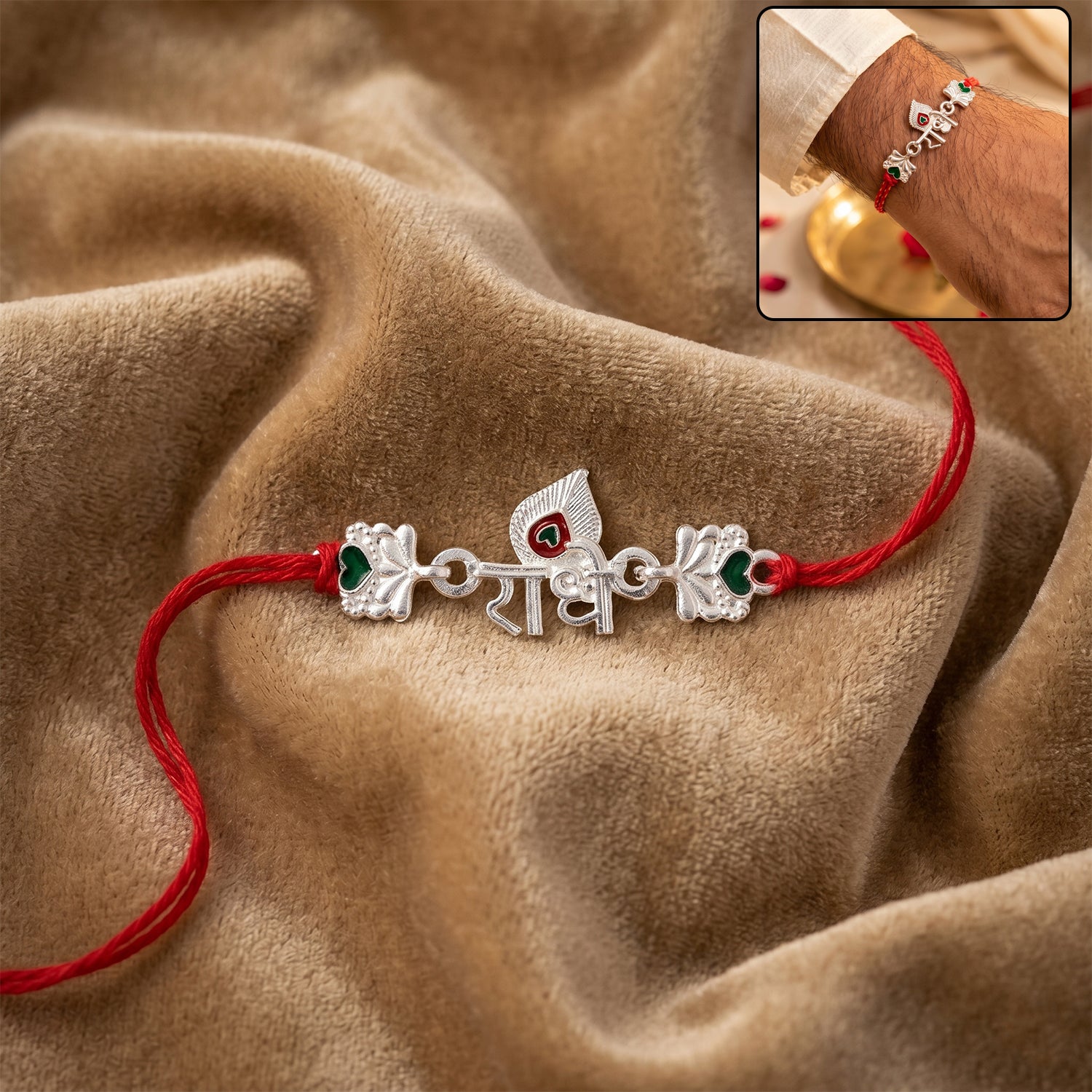 Silver Radhe Morpich Text Rakhi with Green Stones and Red Thread