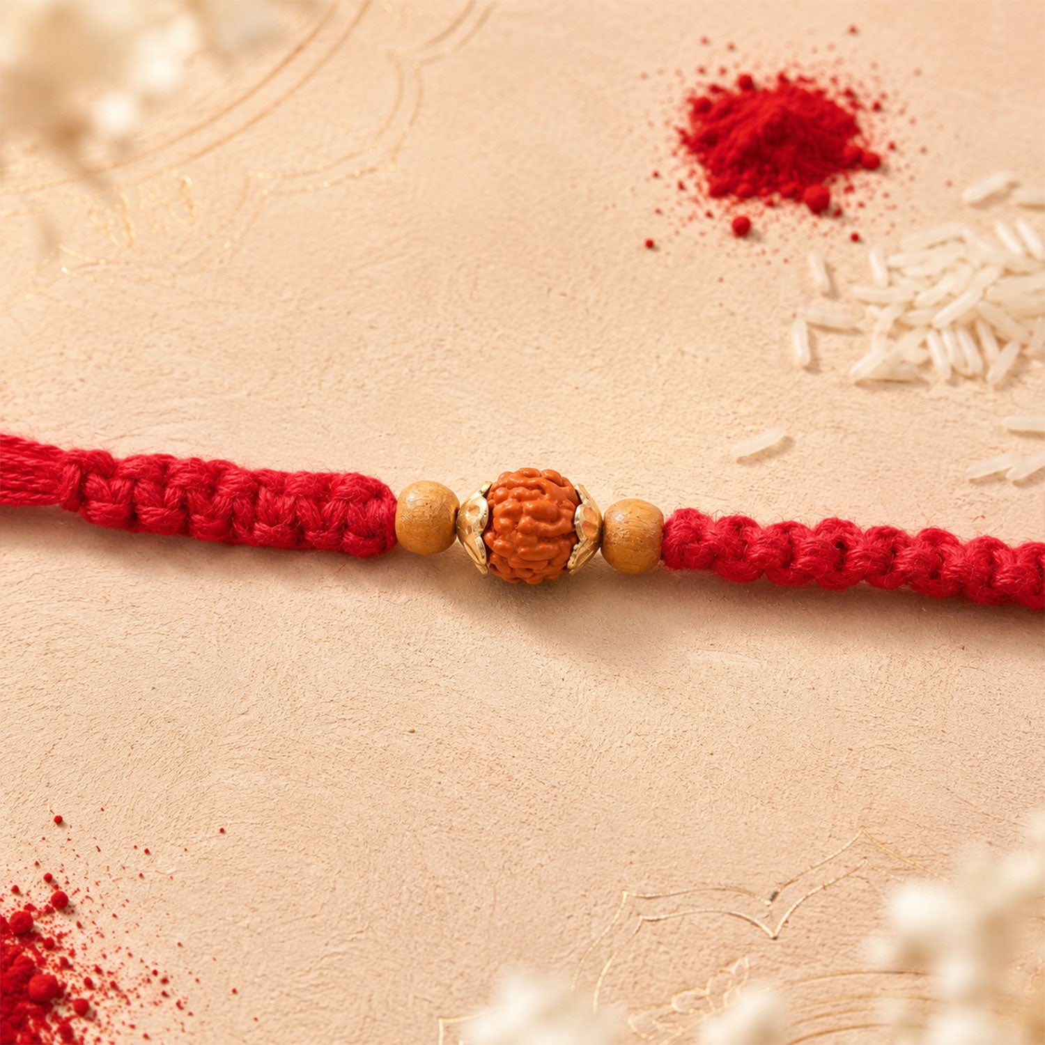 Red Braided Rakhi with a Natural Rudraksha Bead Pendant Accent