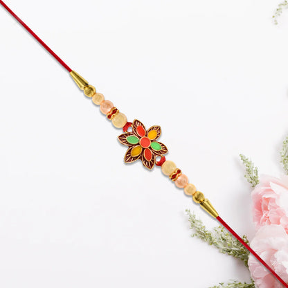 Decorative floral bead rakhi arranged on a festive thali for Rakshabandhan celebration.