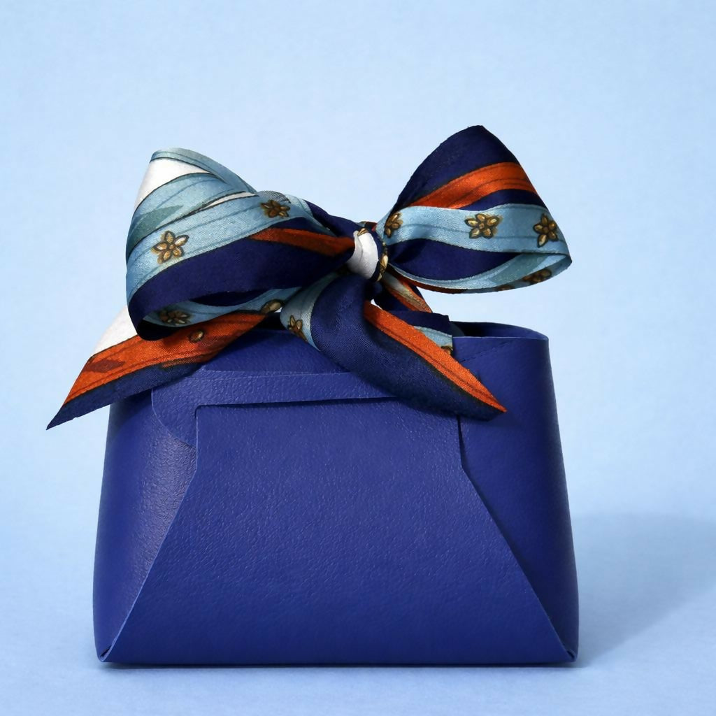 Blue handbag-style cosmetic organizer showing open compartments