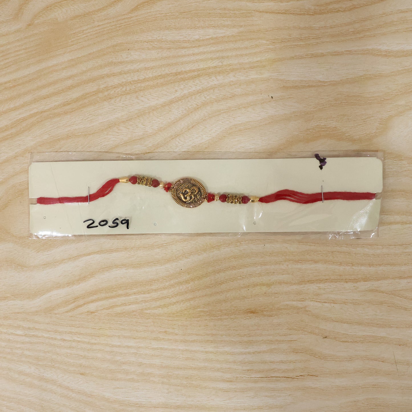 Antique Om Coin Rakhi with Rudraksha Beads and Red Thread