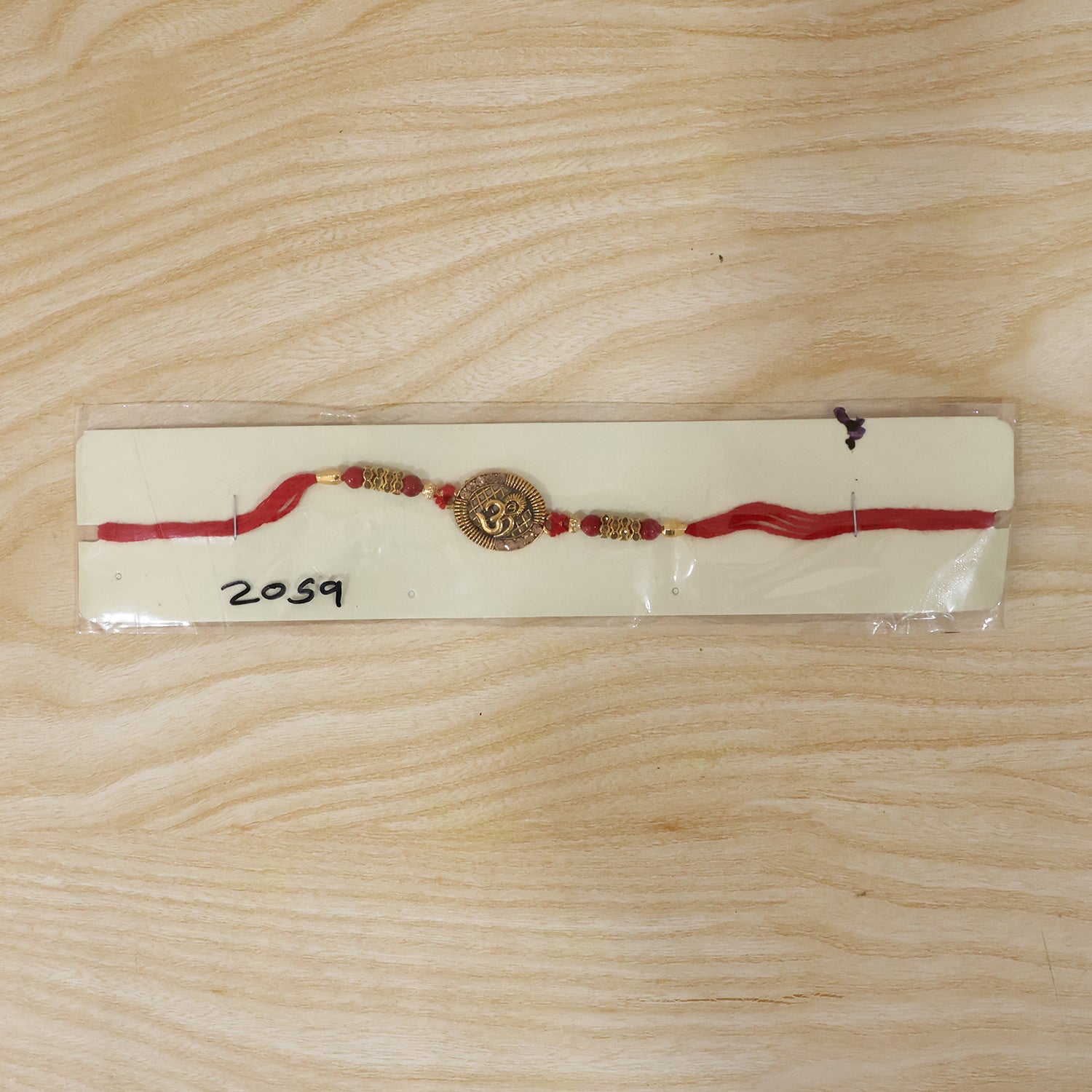 Antique Om Coin Rakhi with Rudraksha Beads and Red Thread
