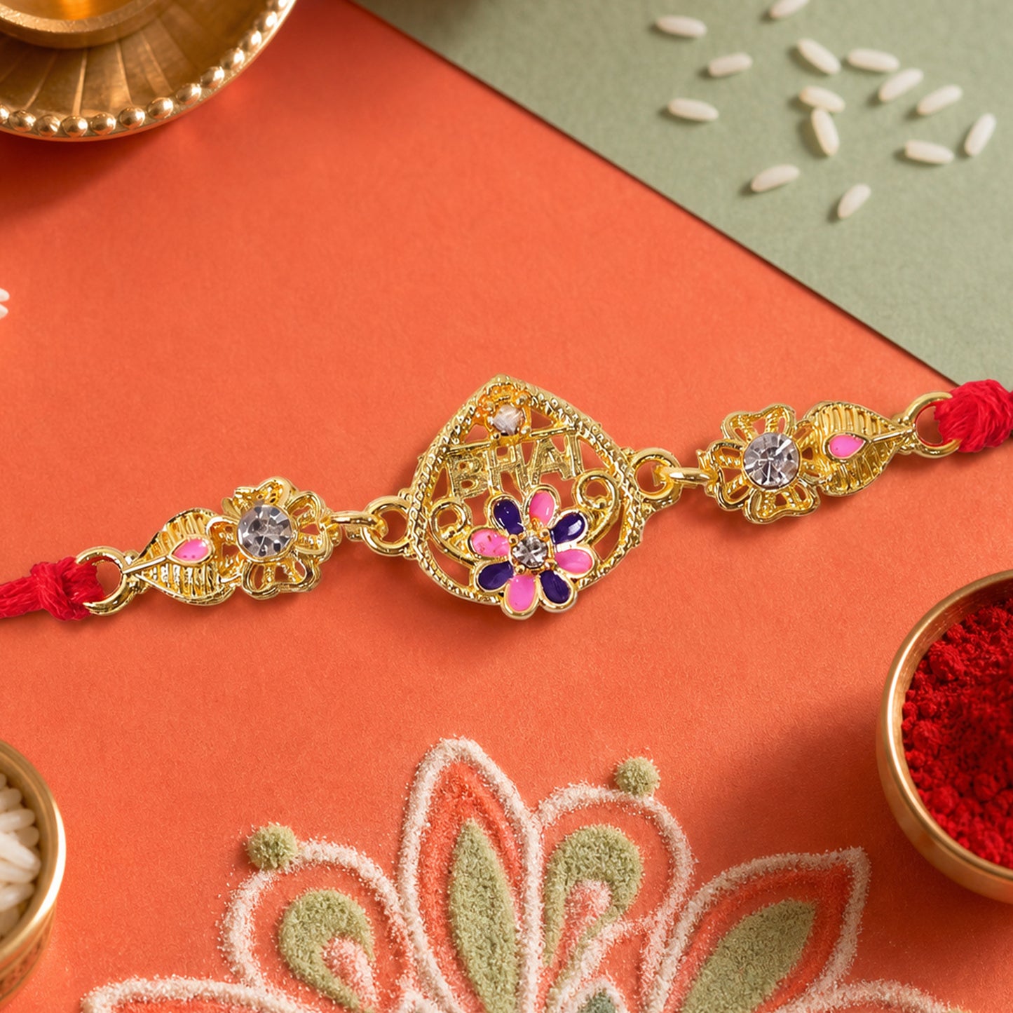 Festive Rakhi featuring Ornate Floral Charm, pearl accents and chain look for Gift