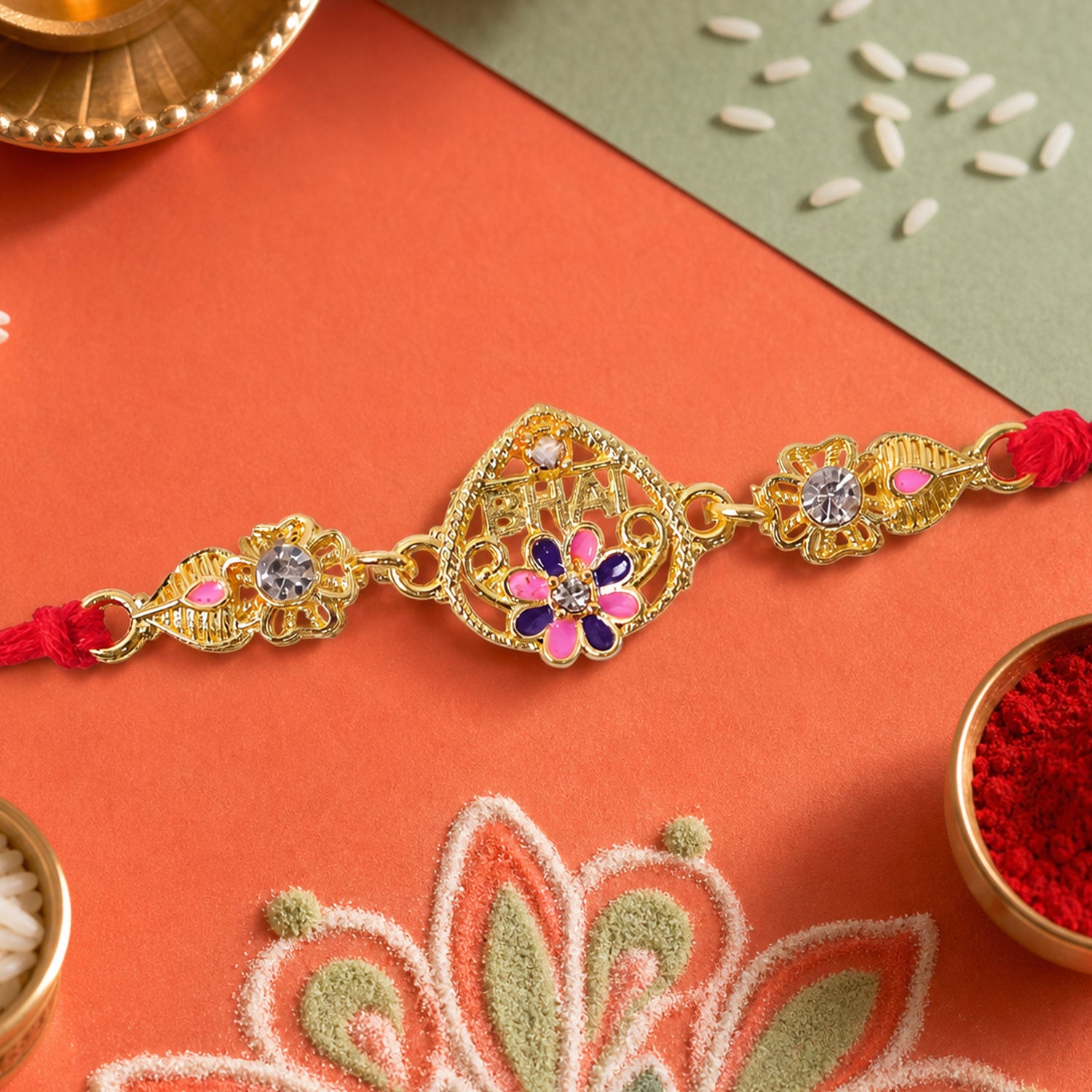 Festive Rakhi featuring Ornate Floral Charm, pearl accents and chain look for Gift
